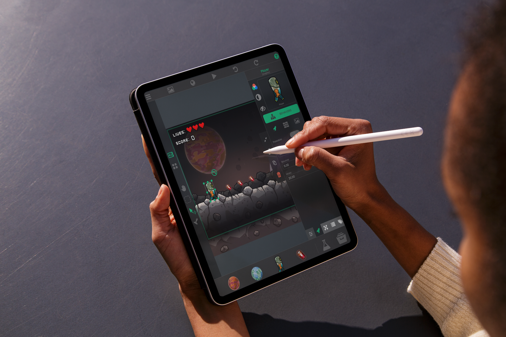 A person developing a game on an iPad